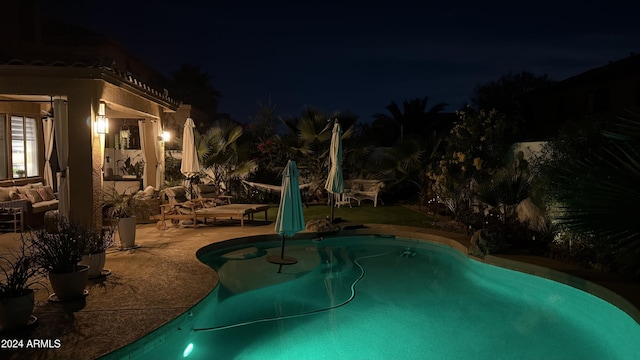 pool at night with a patio