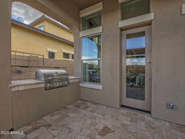 view of patio / terrace with exterior kitchen, fence, and grilling area