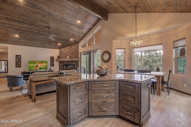 kitchen with a fireplace, wood ceiling, high vaulted ceiling, and light hardwood / wood-style flooring