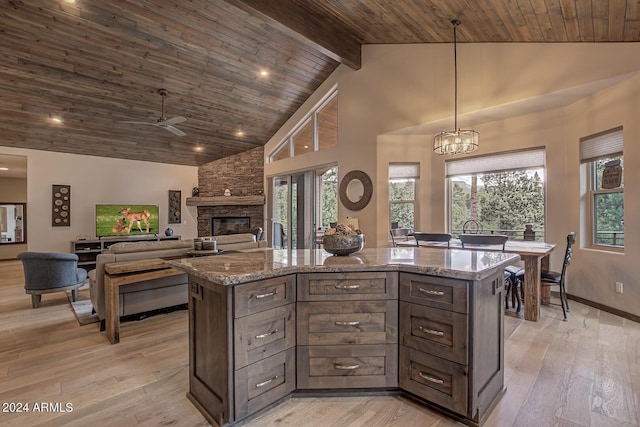 4047 W Forest Ct, Pine, AZ 85544 - kitchen with a fireplace, light stone counters, light wood-style floors, and wooden ceiling