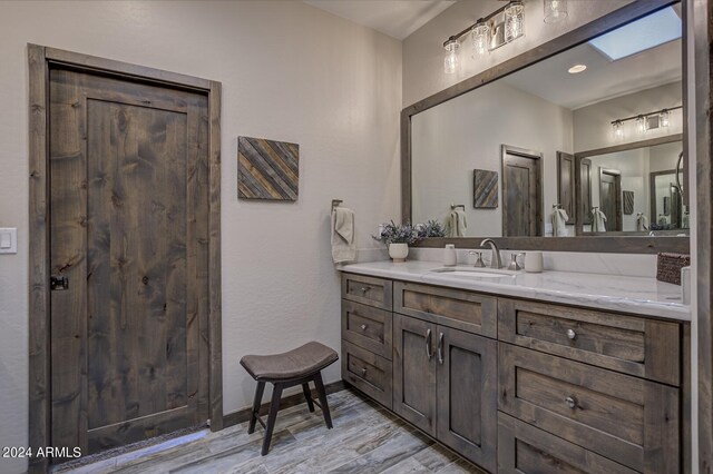 4047 W Forest Ct, Pine, AZ 85544 - bathroom with baseboards, wood finished floors, and vanity