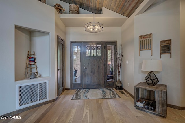 entryway with a chandelier, light hardwood / wood-style flooring, high vaulted ceiling, and wooden ceiling