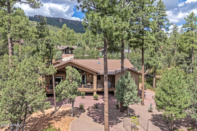 4047 W Forest Ct, Pine, AZ 85544 - rear view of property with metal roof, a standing seam roof, and a view of trees