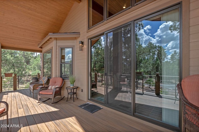 sunroom / solarium featuring wood ceiling and vaulted ceiling