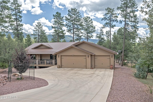 4047 W Forest Ct, Pine, AZ 85544 - view of front of property with a standing seam roof, metal roof, an attached garage, driveway, and a porch
