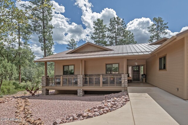 4047 W Forest Ct, Pine, AZ 85544 - view of front of house featuring a porch, a standing seam roof, and metal roof
