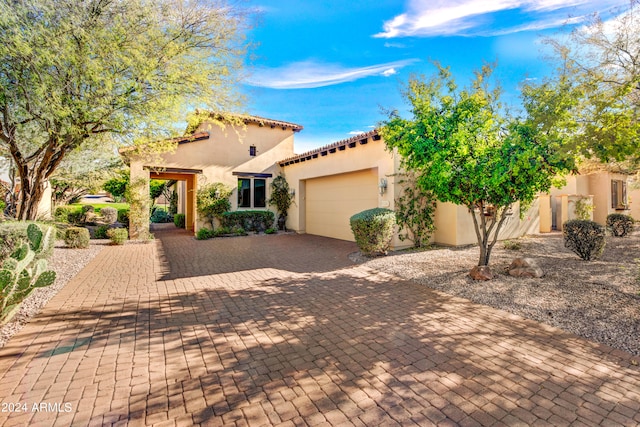 mediterranean / spanish home with a garage