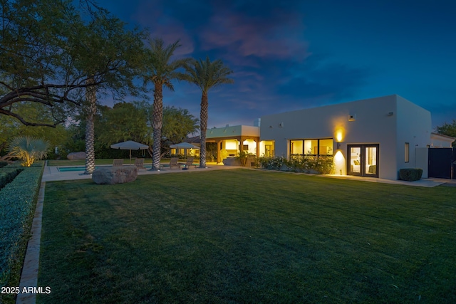 6648 E Horseshoe Rd, Paradise Valley, AZ 85253 - back of house with french doors, a lawn, an outdoor pool, a patio area, and stucco siding