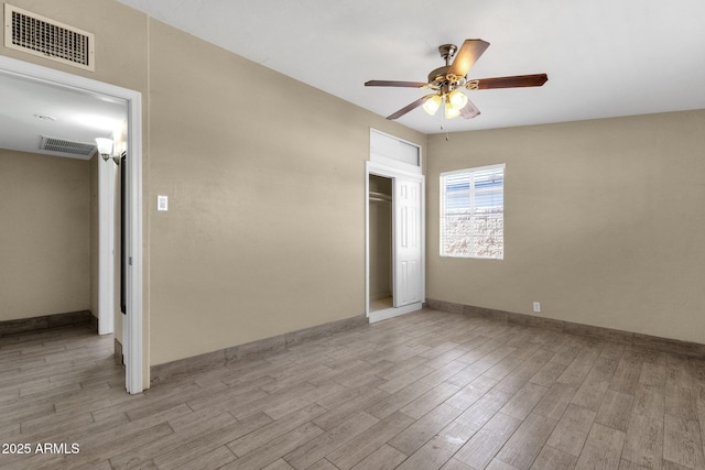 unfurnished bedroom featuring a closet, light wood-type flooring, and visible vents