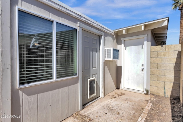 doorway to property featuring fence