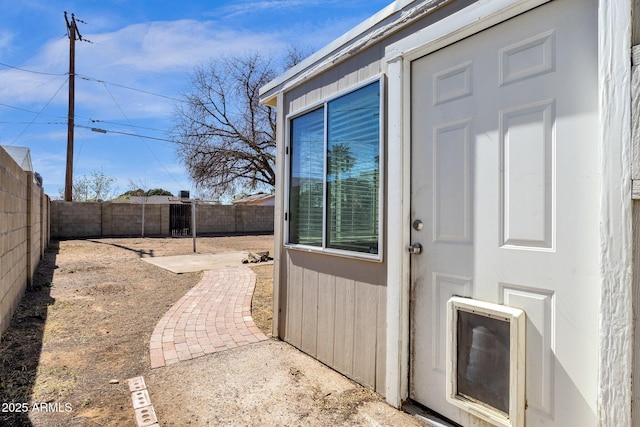 doorway to property with fence