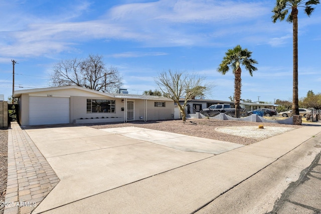 single story home featuring a garage and concrete driveway