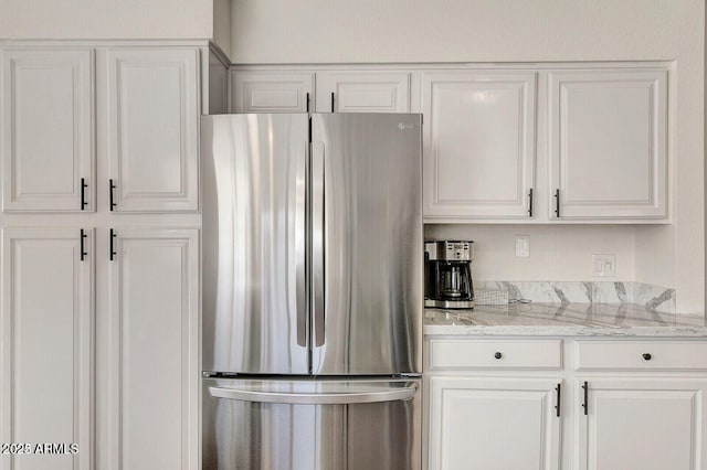 101 N 7th St Unit 225, Phoenix, AZ 85034 - kitchen featuring freestanding refrigerator and white cabinetry