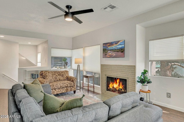 101 N 7th St Unit 225, Phoenix, AZ 85034 - living room with a ceiling fan, wood finished floors, and a tiled fireplace