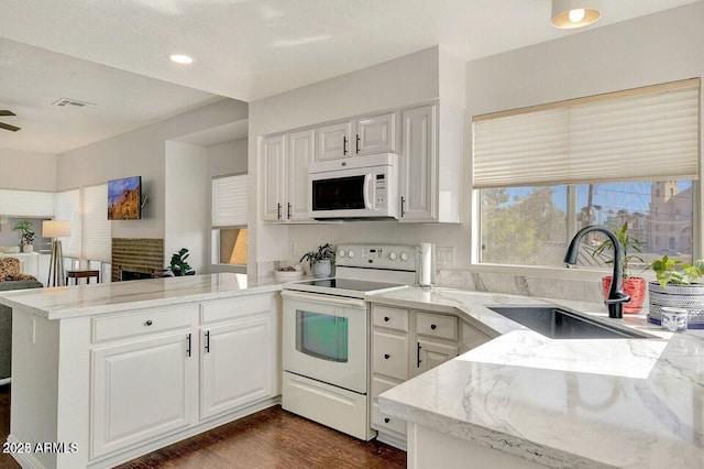 101 N 7th St Unit 225, Phoenix, AZ 85034 - kitchen with white appliances, a peninsula, white cabinets, and recessed lighting