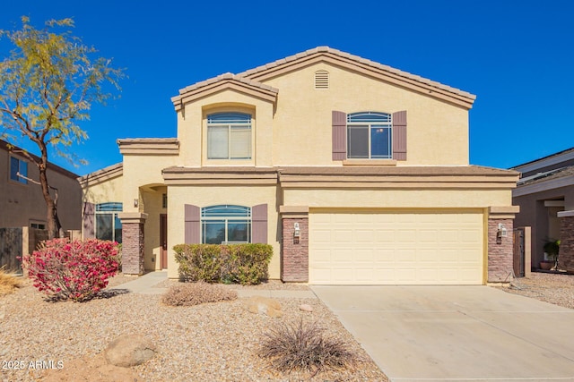 view of front of property featuring driveway, an attached garage, and stucco siding