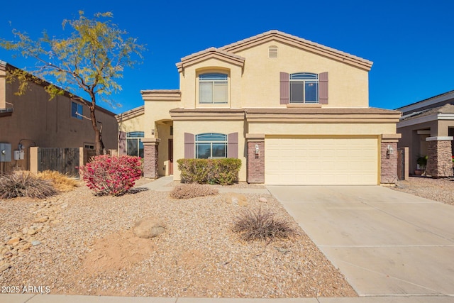 view of front facade with driveway, an attached garage, fence, and stucco siding