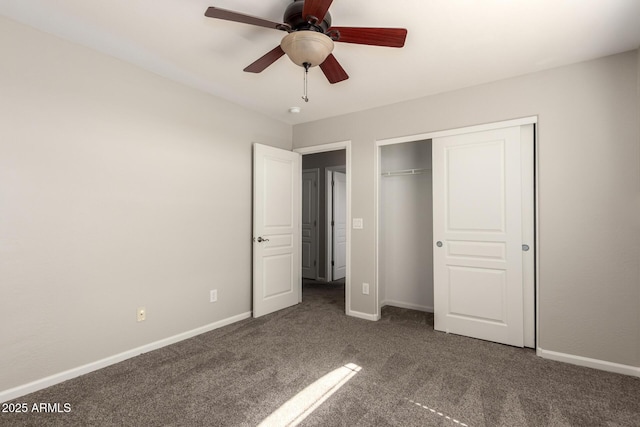 unfurnished bedroom with a ceiling fan, baseboards, dark colored carpet, and a closet