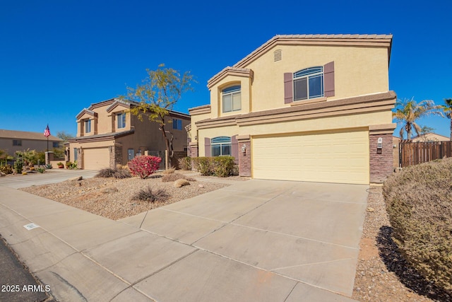 view of front of property with a garage, driveway, and stucco siding