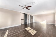 empty room with baseboards and wood finished floors