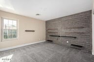 unfurnished living room featuring baseboards