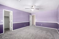 interior space with ceiling fan and carpet floors