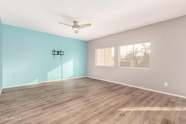 empty room featuring ceiling fan and light hardwood / wood-style flooring