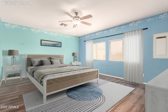 bedroom with ceiling fan and hardwood / wood-style floors