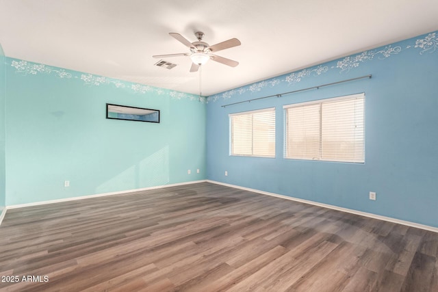 empty room with hardwood / wood-style floors and ceiling fan