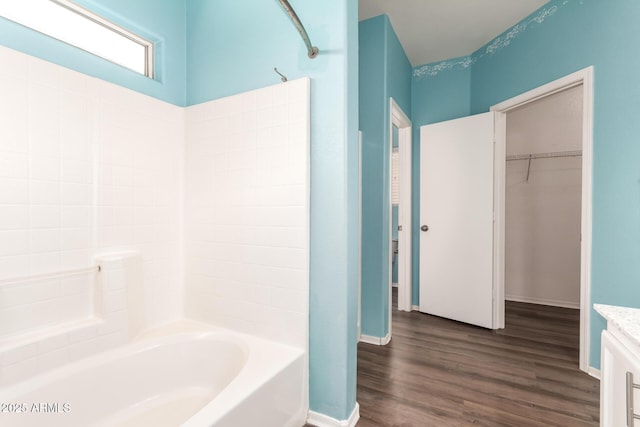 bathroom with hardwood / wood-style flooring, vanity, and shower / bath combination