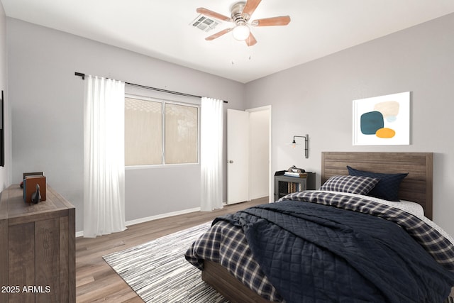 bedroom featuring multiple windows, light hardwood / wood-style flooring, and ceiling fan