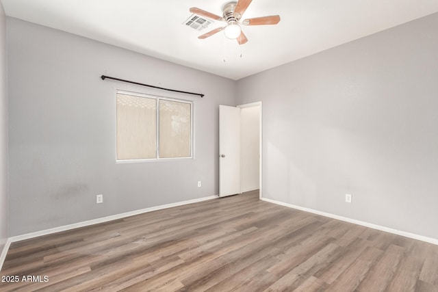 unfurnished room featuring hardwood / wood-style flooring and ceiling fan