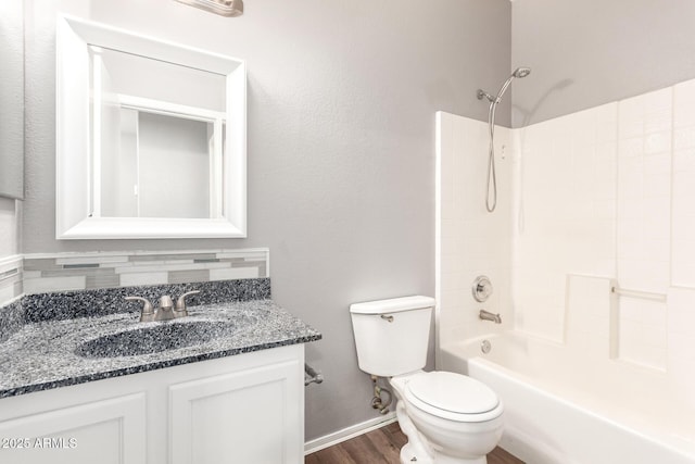 full bathroom featuring hardwood / wood-style flooring, shower / tub combination, vanity, and toilet