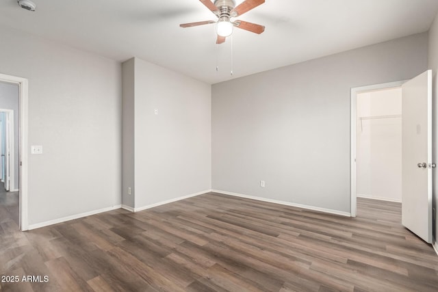 empty room featuring ceiling fan and dark hardwood / wood-style flooring