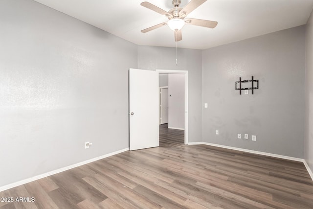 unfurnished room with hardwood / wood-style flooring and ceiling fan