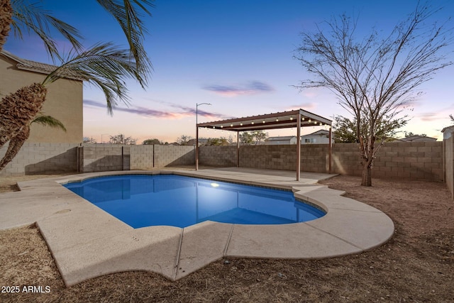 pool at dusk featuring a patio