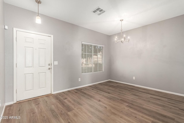 interior space featuring hardwood / wood-style flooring and a chandelier