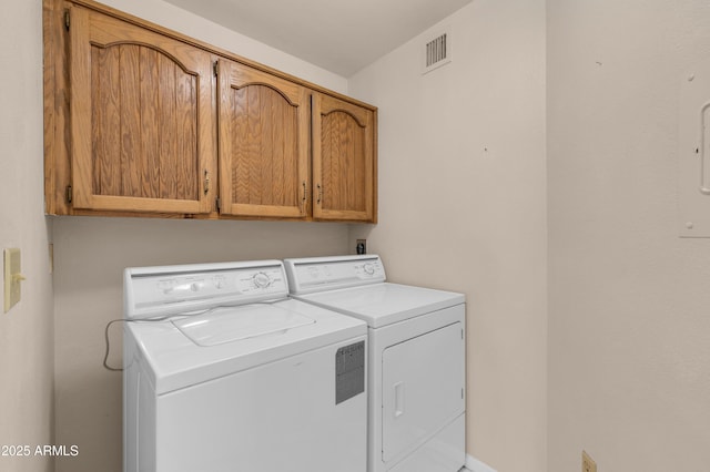 clothes washing area with cabinet space, independent washer and dryer, and visible vents