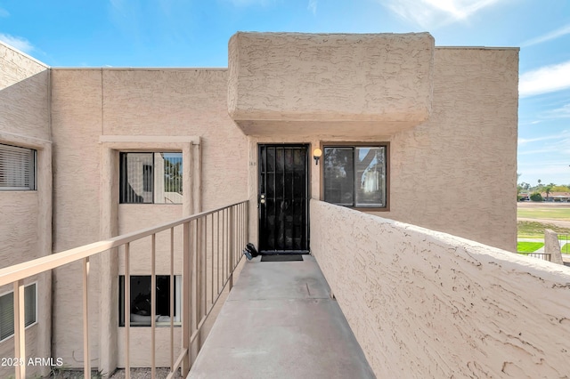 entrance to property with stucco siding