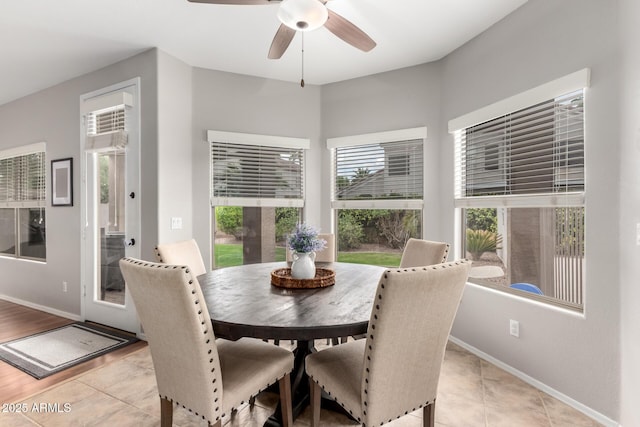 dining space with light tile patterned floors, ceiling fan, and baseboards