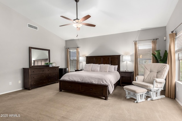 bedroom with visible vents, baseboards, light colored carpet, vaulted ceiling, and a ceiling fan