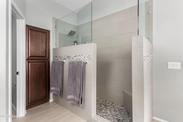 bathroom featuring walk in shower and wood finished floors