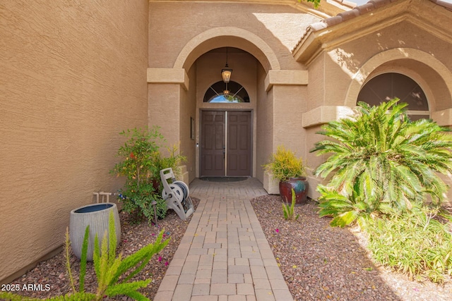 view of exterior entry with stucco siding