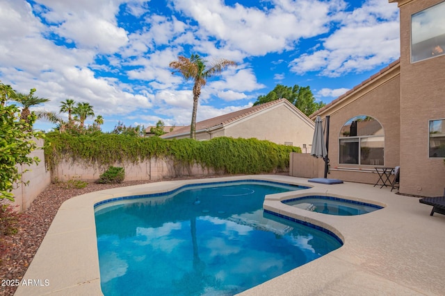 view of pool featuring a fenced in pool, an in ground hot tub, a fenced backyard, and a patio area