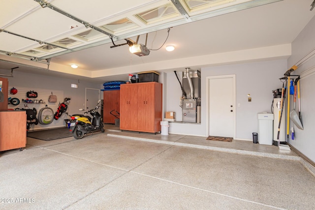 garage featuring baseboards, heating unit, and a garage door opener