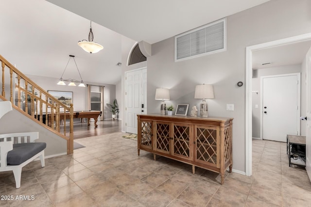 interior space with visible vents, lofted ceiling, baseboards, and stairway