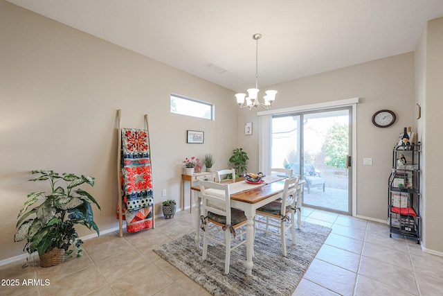 dining area with a chandelier and light tile patterned flooring