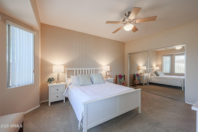 carpeted bedroom with ceiling fan and a closet