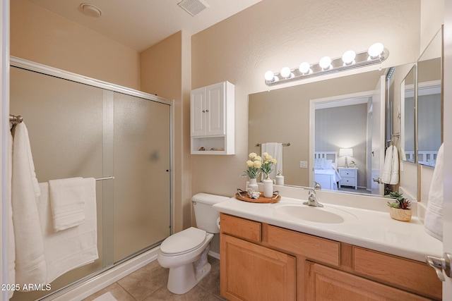 bathroom featuring tile patterned floors, toilet, a shower with door, and vanity