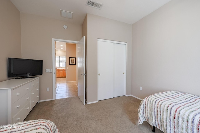 bedroom with a closet and light carpet